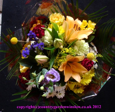 Mixed Hand tie H T6 with peach lillies, yellow roses and yellow scented fresias